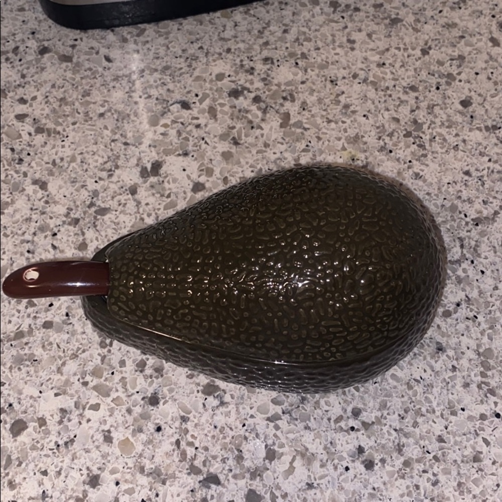 Guacamole ceramic container with serving ladle.